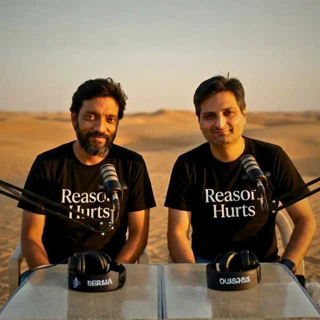 Umesh and Sachin, hosts of Reason Hurts, at a podcast table in the desert