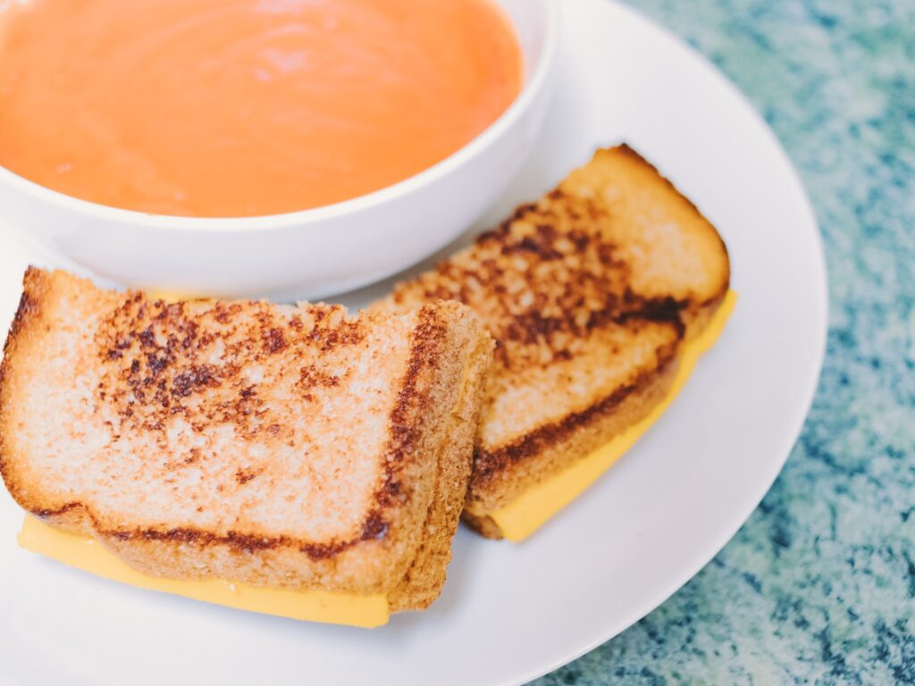 A comfort food of grilled cheese with tomato soup