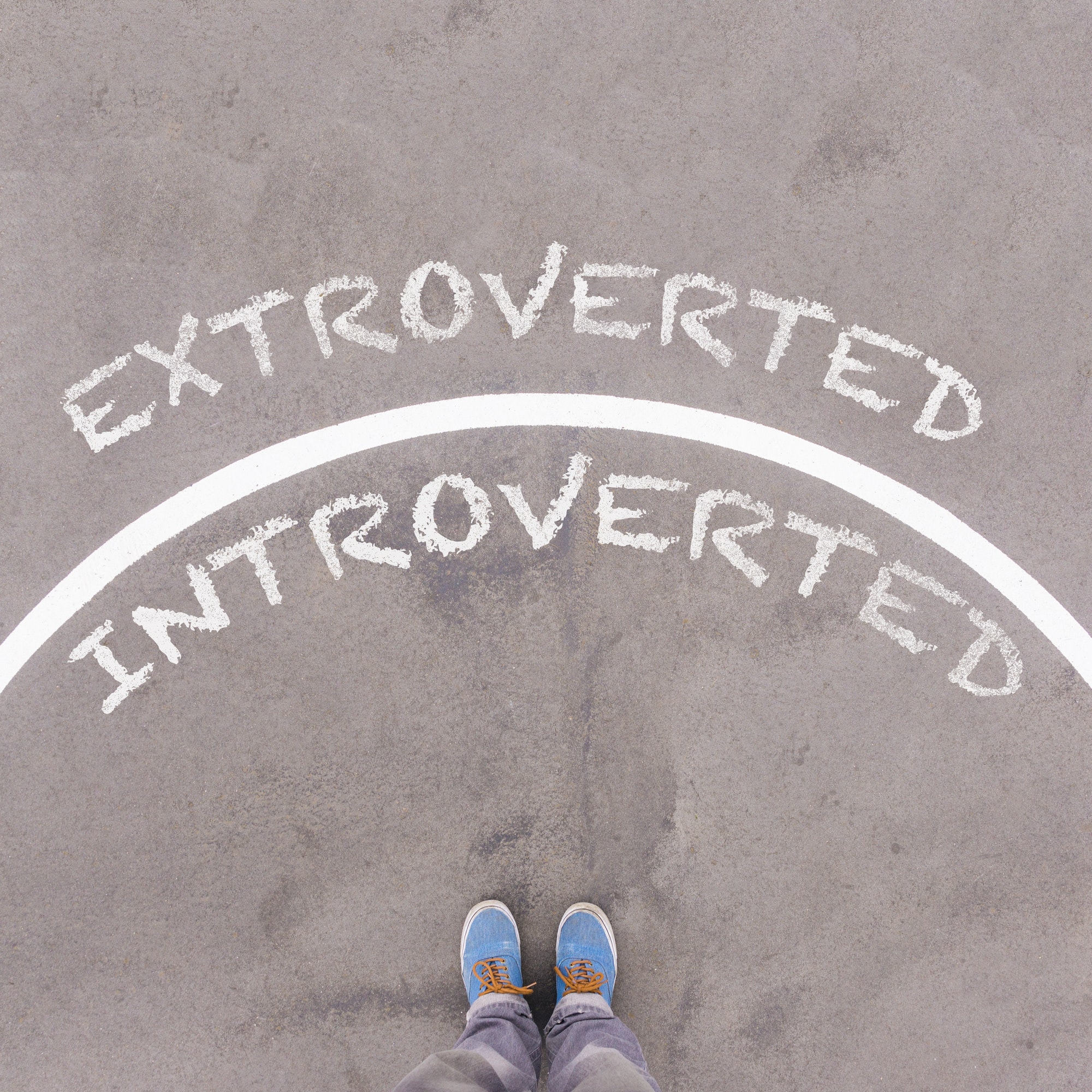 Extroverted vs Introverted text on asphalt ground