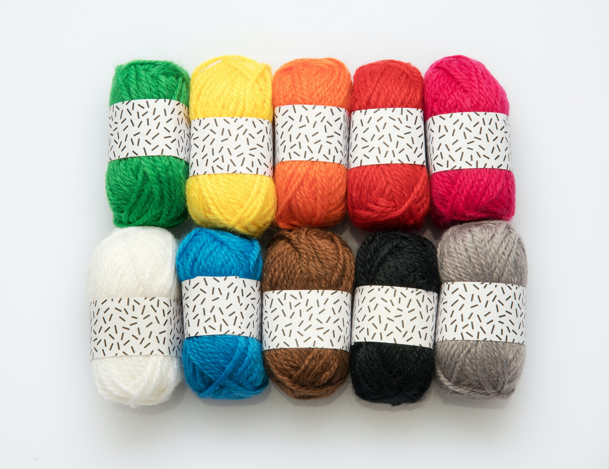 Ten assorted colors of wool yarn in balls